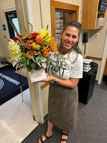 picture of McKinley Principal Rhiannon Treat holding up a bouquet of flowers